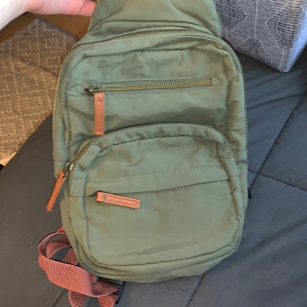A green crossbody book bag